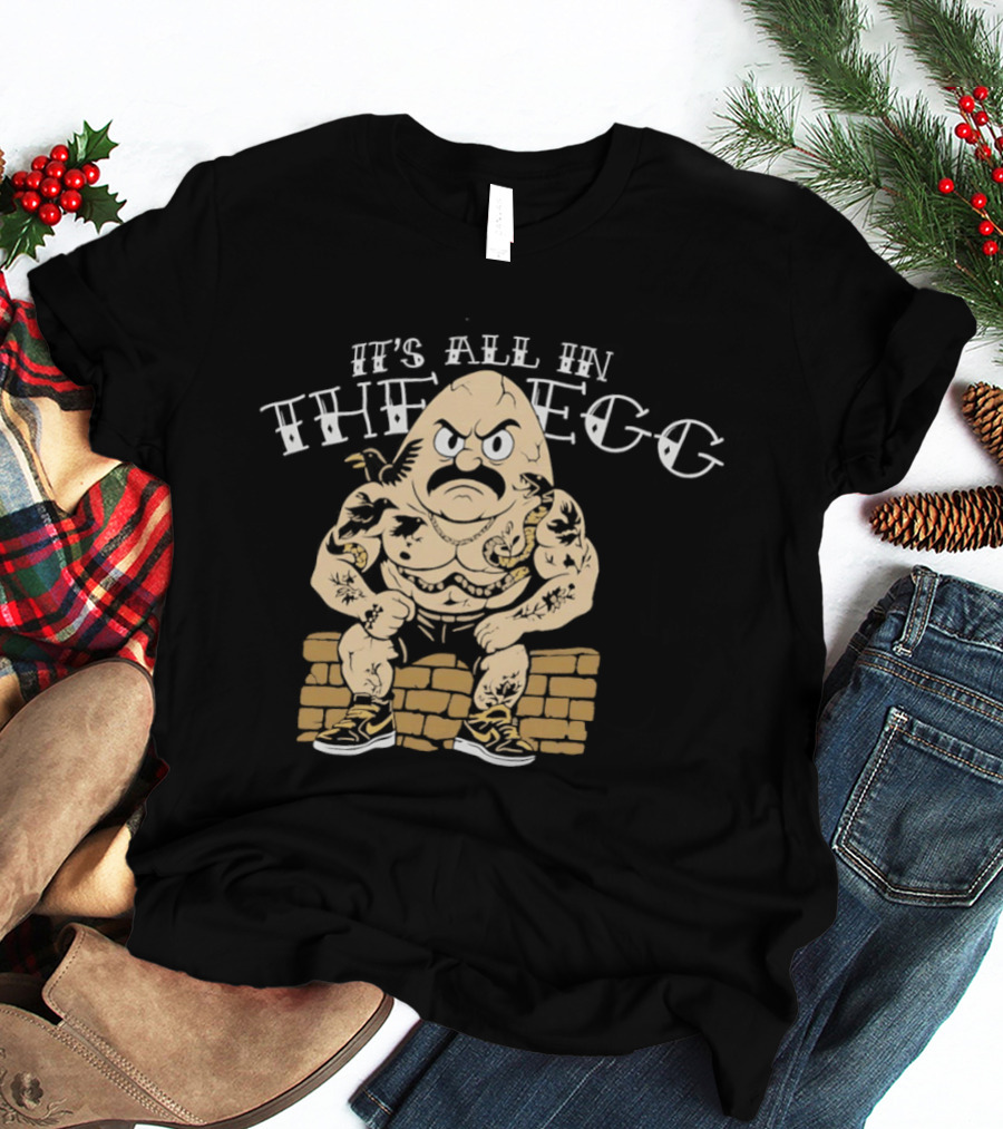 It's All In The Egg Muscular Cartoon Character With Mustache Sitting On Brick Wall T-Shirt