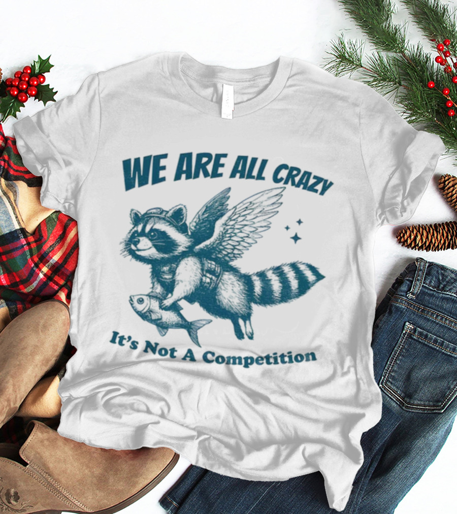 Raccoon With Wings Holding Fish We Are All Crazy It's Not A Competition T-Shirt