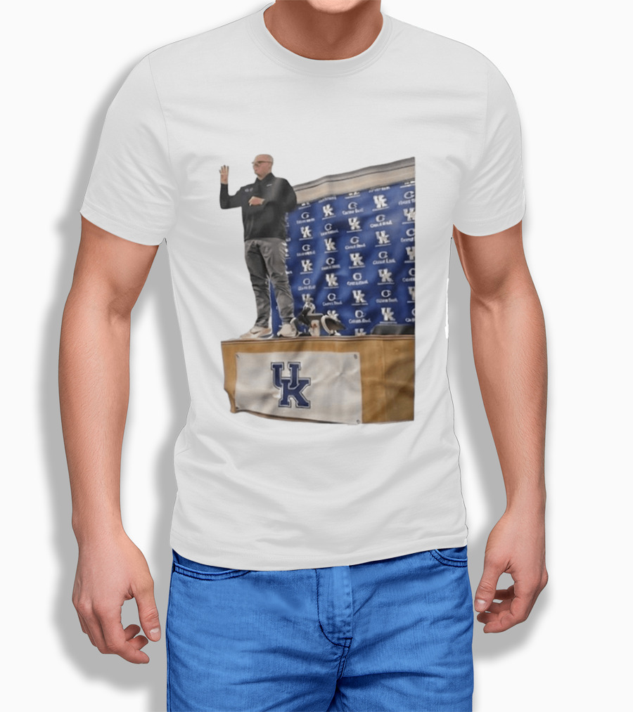UK Volleyball Coach Craig Skinner Standing On Table With UK Logo And Awards T-Shirt