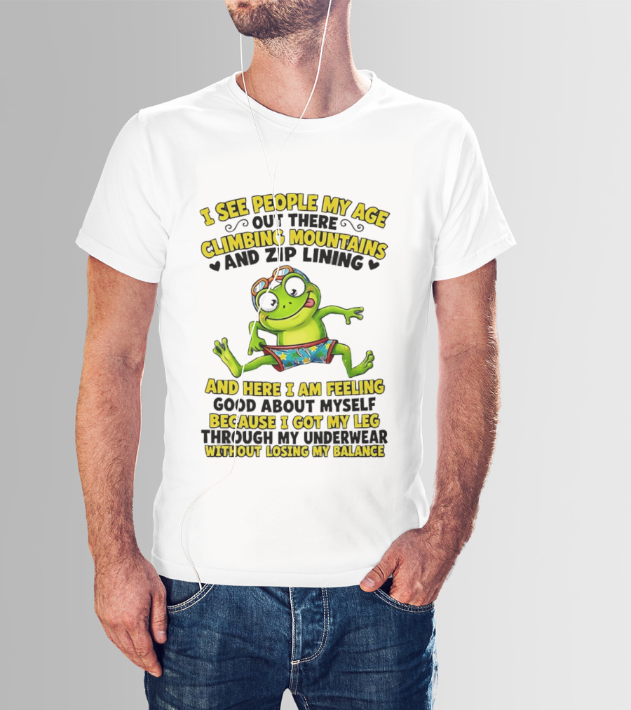 I See People My Age Climbing Mountains And Zip Lining Cartoon Frog Feeling Good Without Losing Balance T-Shirt