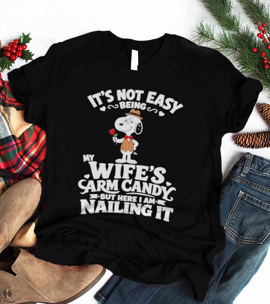 Snoopy It's Not Easy Being My Wife's Arm Candy But Here I Am Nailing It T-Shirt