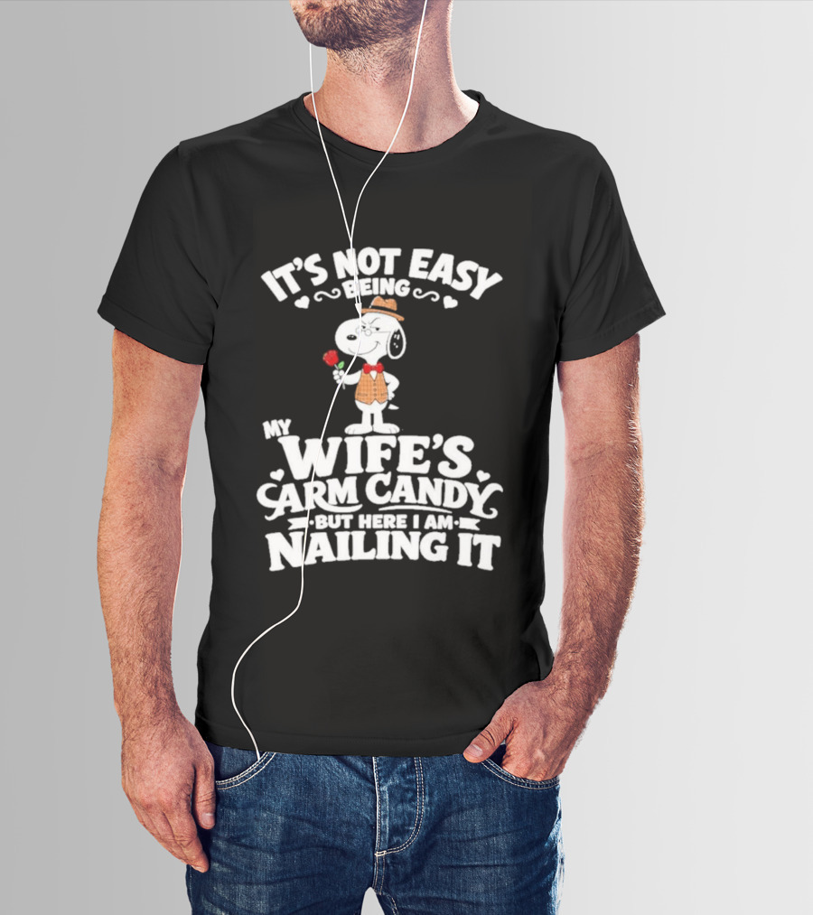 Snoopy It's Not Easy Being My Wife's Arm Candy But Here I Am Nailing It T-Shirt