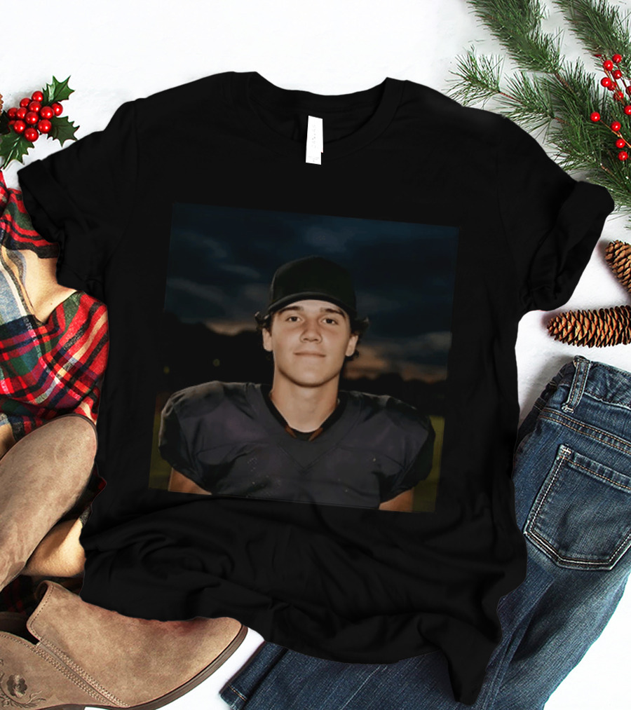 Young Football Athlete Wearing Black Cap And Shoulder Pads T-Shirt